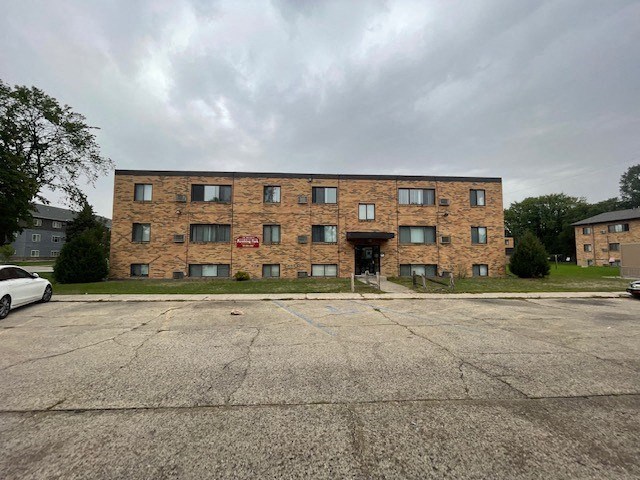 a large brick building with a parking lot