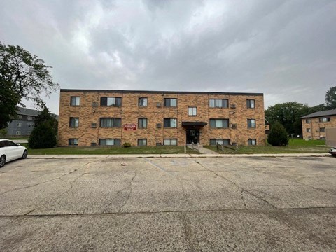 a large brick building with a parking lot