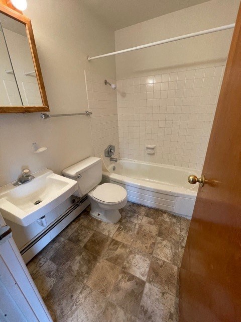a bathroom with a toilet and a sink and a bath tub