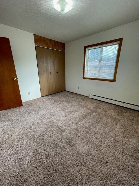 an empty room with a door and a window