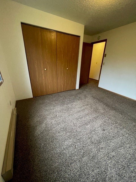 an empty room with a carpet floor and a door
