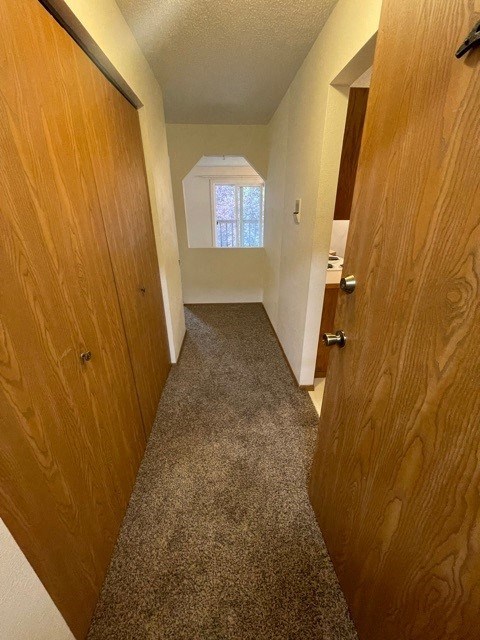 a hallway with a door open to a room with a window
