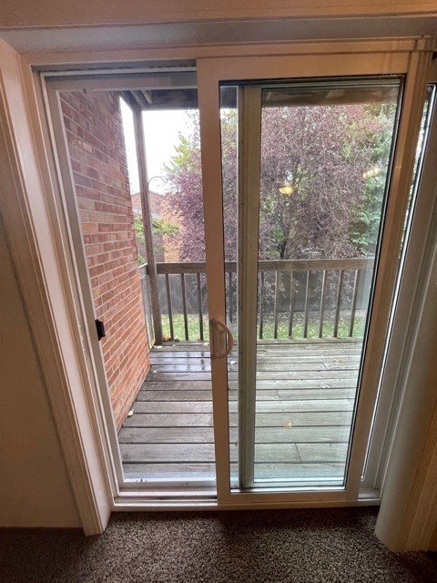 a room with a sliding glass door and a balcony