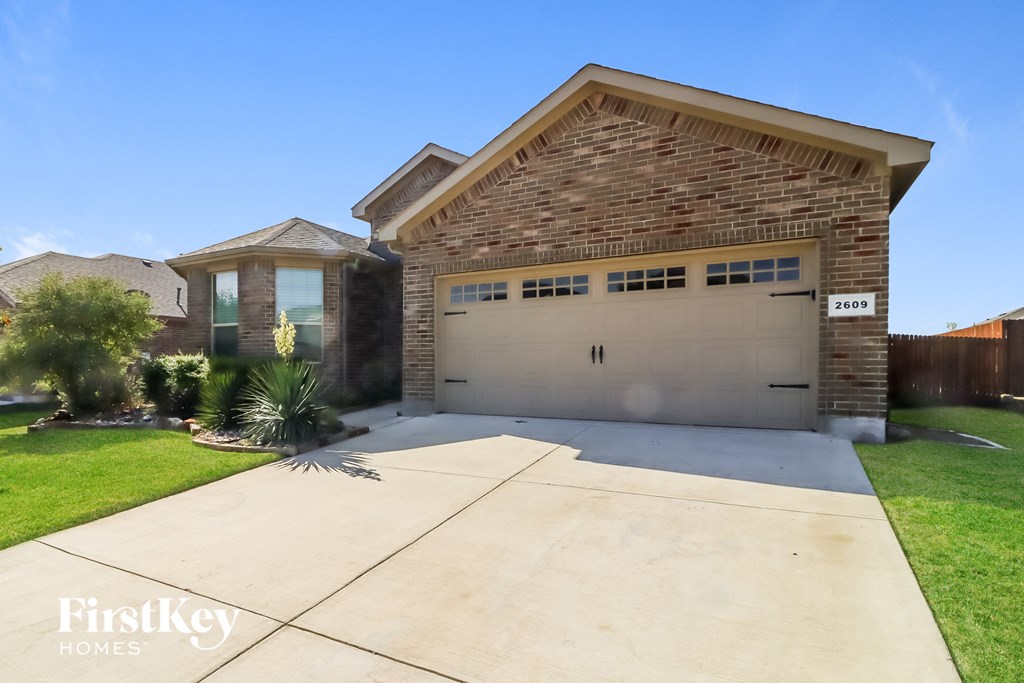 a house with a driveway and a garage door