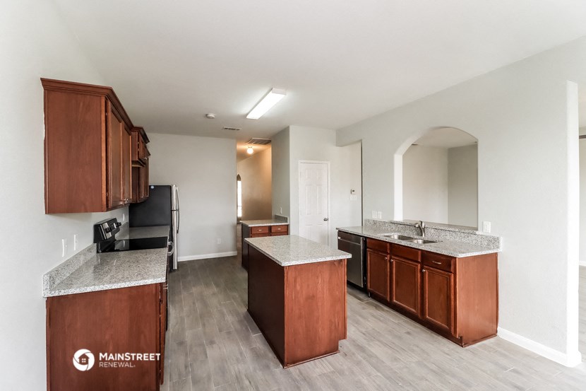 a kitchen with wood cabinets and granite counter tops and