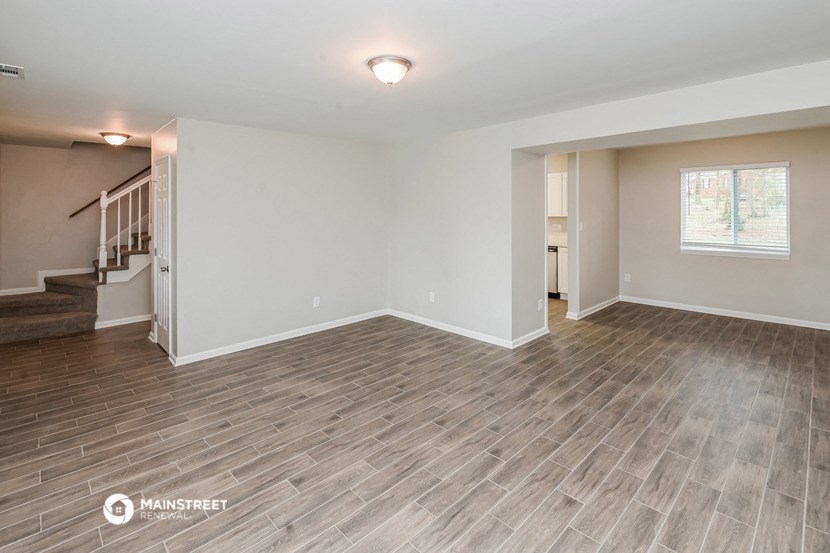 the living room and dining room with wood flooring