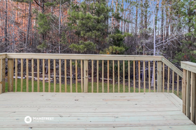 a wooden deck with a forest in the background