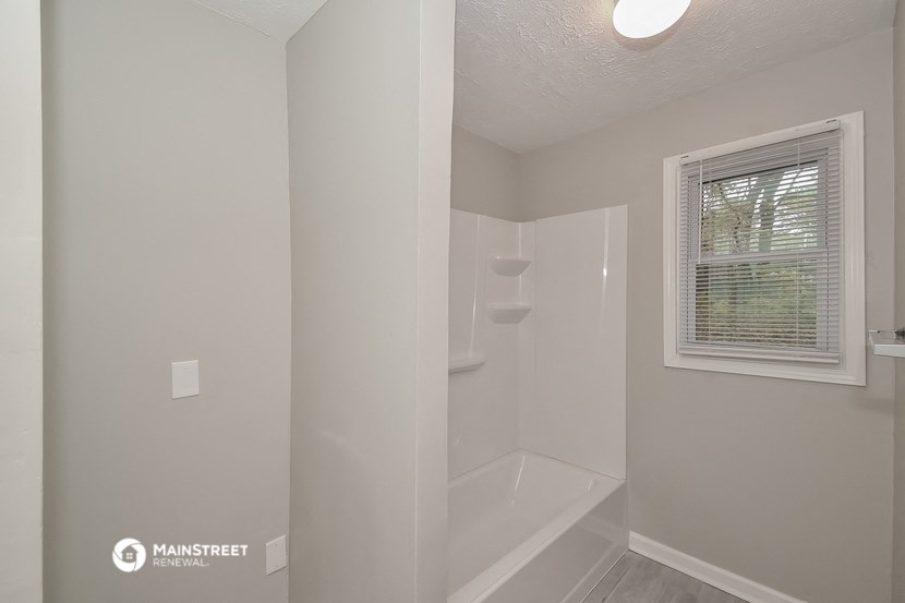 the interior of a bathroom with a shower and a toilet