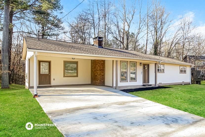 a yellow and with a driveway and a yard