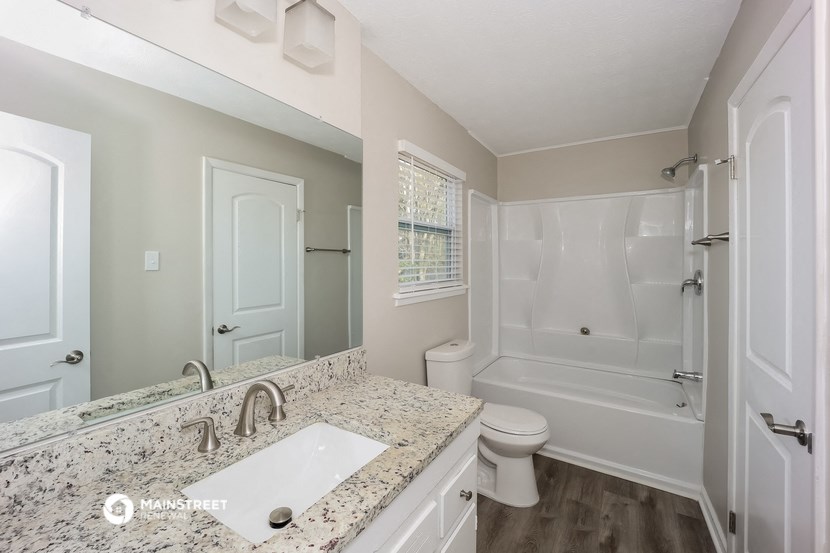 a bathroom with a sink and a toilet and a shower