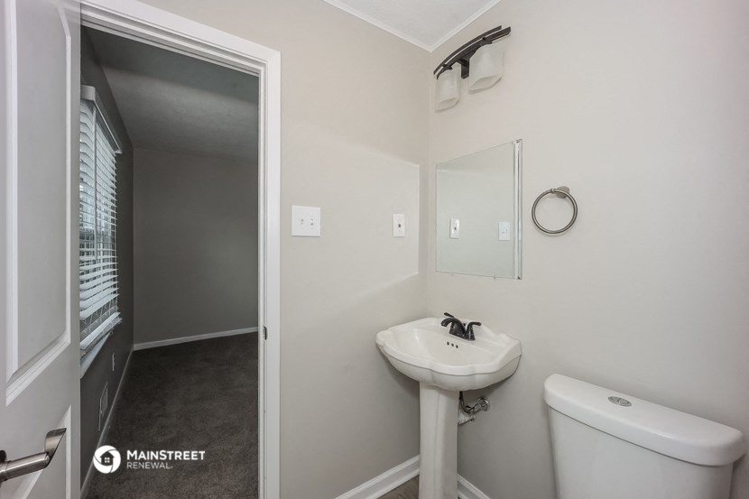 a small bathroom with a sink and a mirror and a toilet