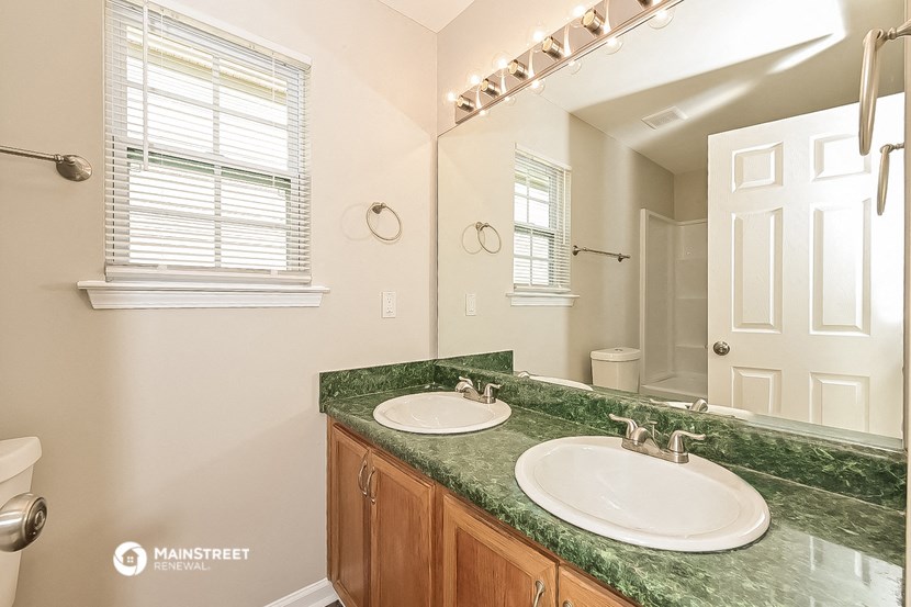 a bathroom with two sinks and a large mirror
