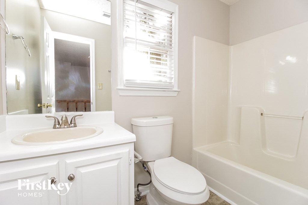 a bathroom with a sink toilet and a bath tub