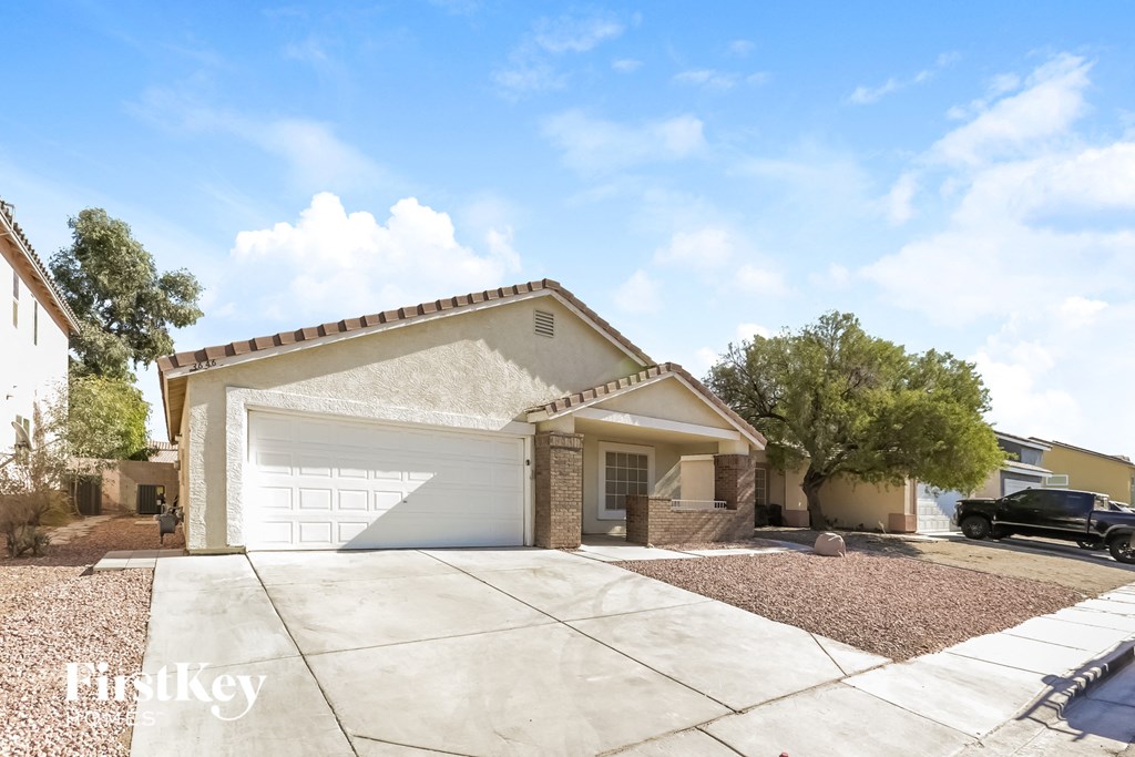 a home with a white garage door and a driveway