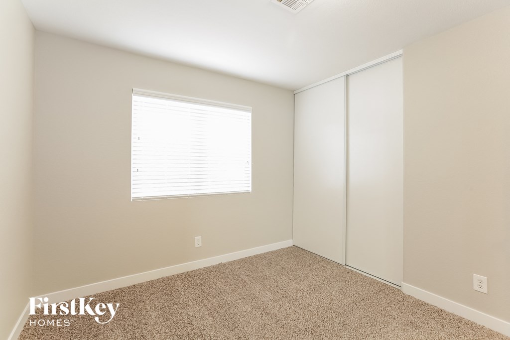 a bedroom with a closet and a window
