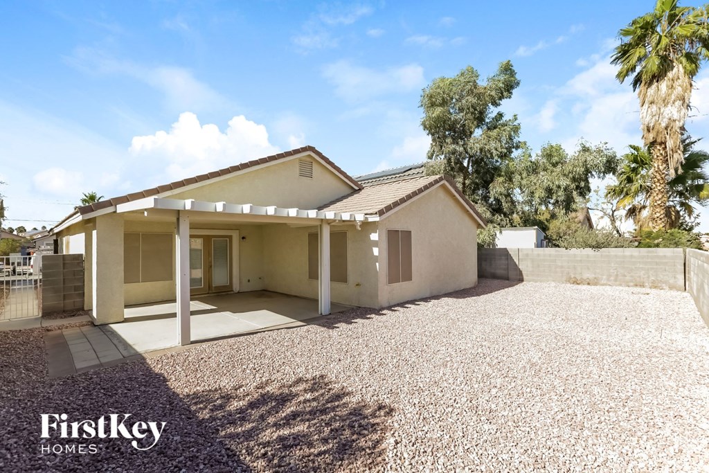 a small house with a gravel driveway and a garage