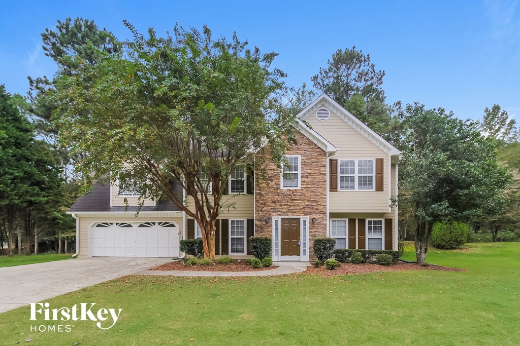 a house with a lawn and a tree in front of it