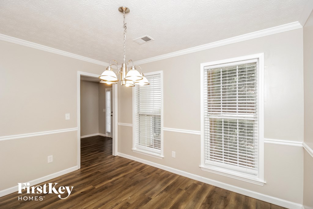 the living room and dining room of an empty house