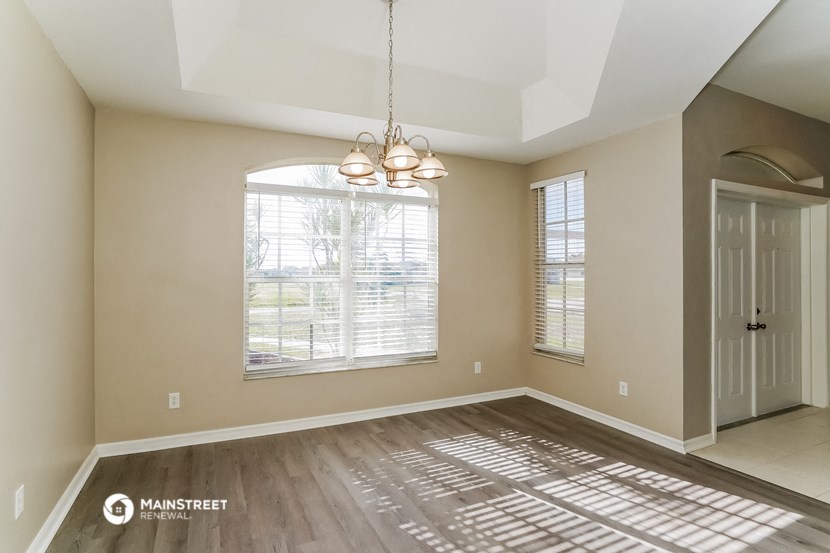 an empty living room with a large window