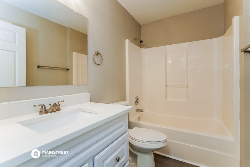 a bathroom with a sink and a toilet and a tub