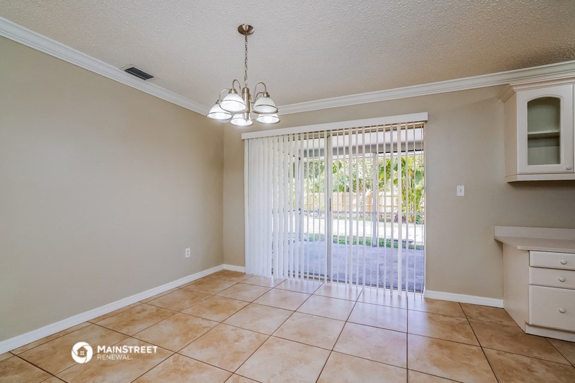 the living room and dining room with a sliding glass door to the patio