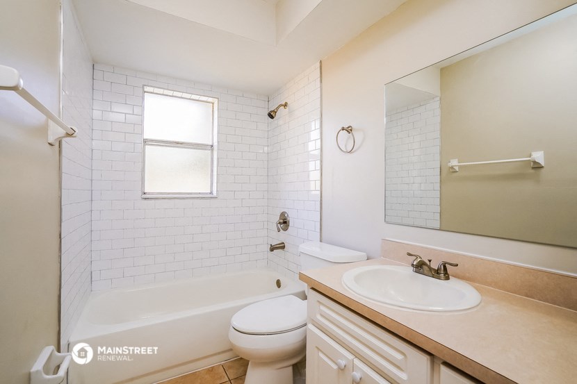 a bathroom with a sink toilet and a bath tub