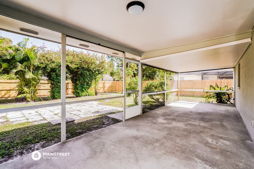a patio in a house with glass doors and a yard