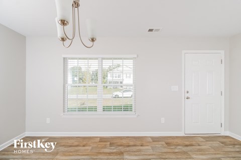 a living room with a window and a white door