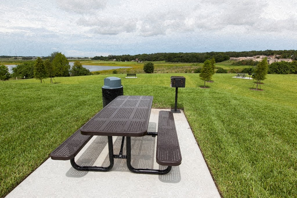 a picnic table with benches in a park
