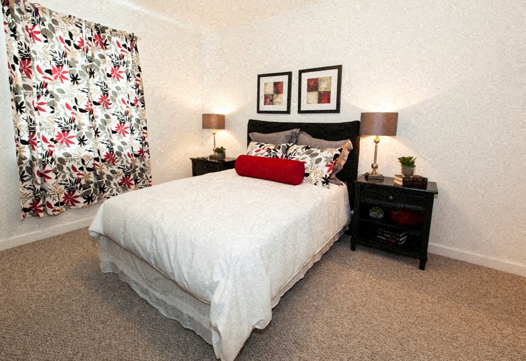 a bedroom with a bed and two night stands