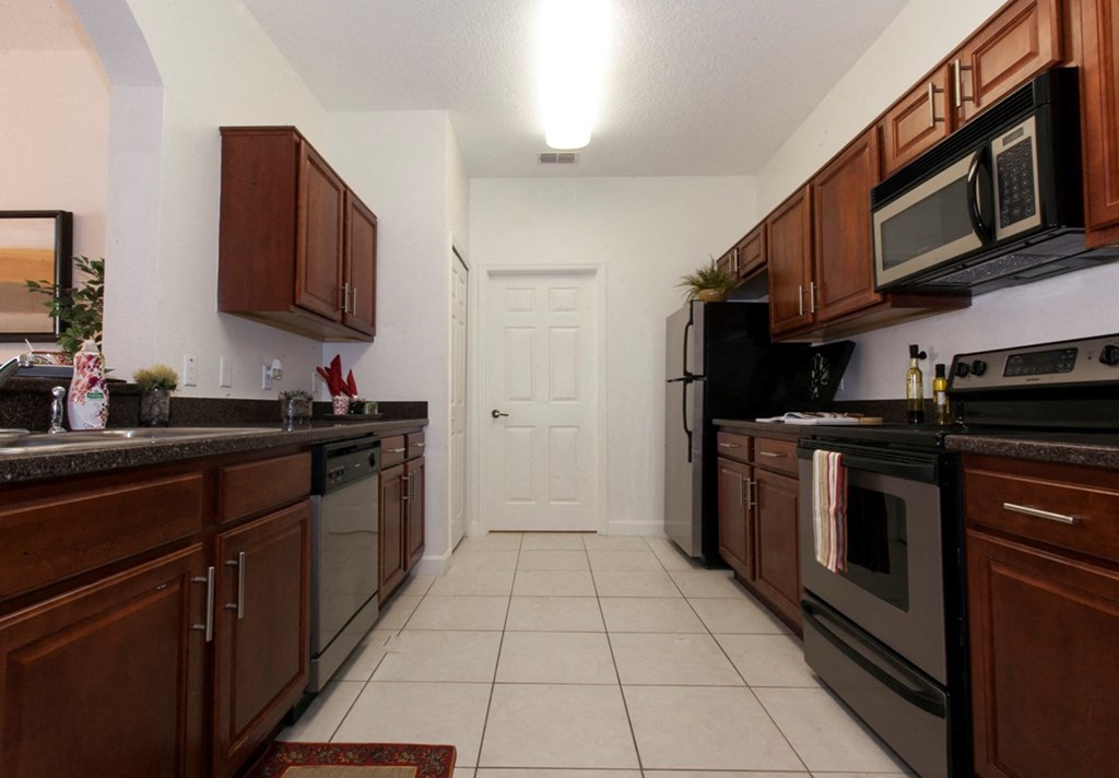 a kitchen with stainless steel appliances and wooden cabinets
