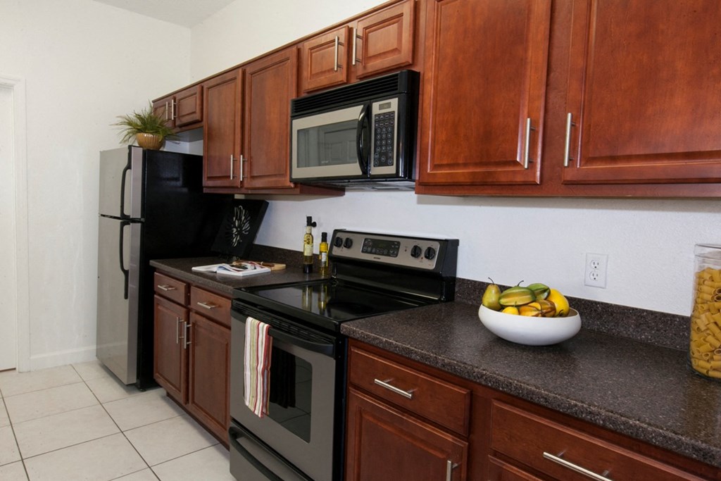 a kitchen with stainless steel appliances and wooden cabinets