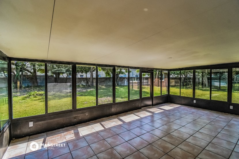 the interior of a house with windows overlooking a yard