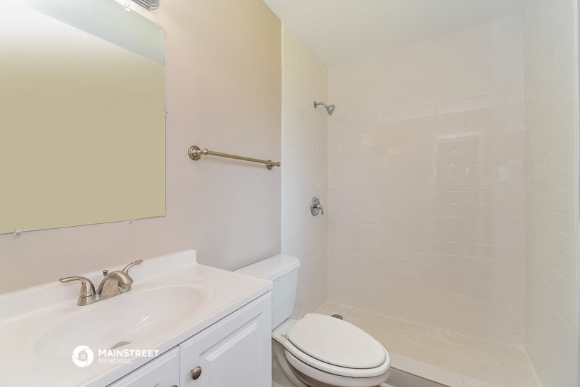 a bathroom with a sink and a toilet and a shower