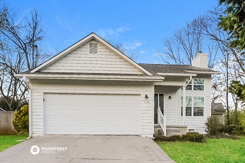 a white house with a white garage door