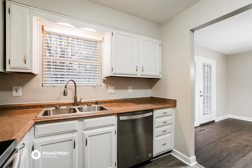 a kitchen with white cabinets and a sink