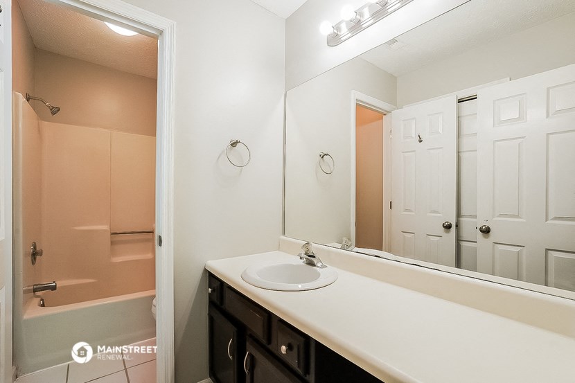 a bathroom with a sink and a mirror and a shower