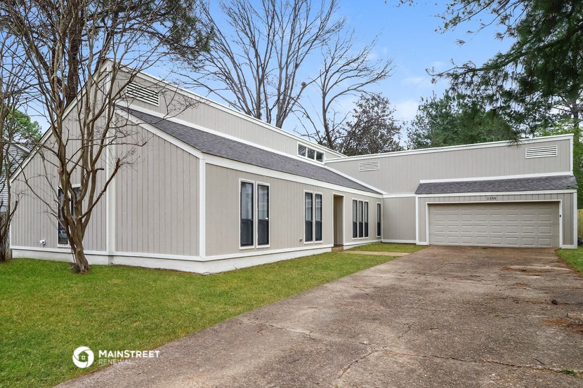 a white and gray house with a driveway and a garage door