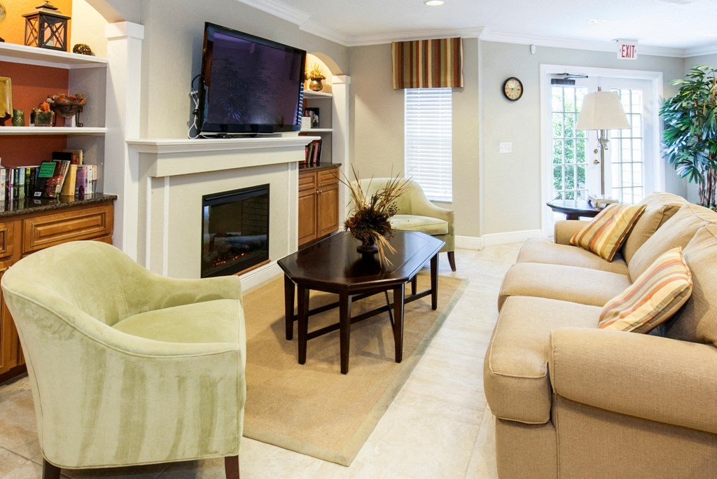 a living room with a couch and a table and a fireplace