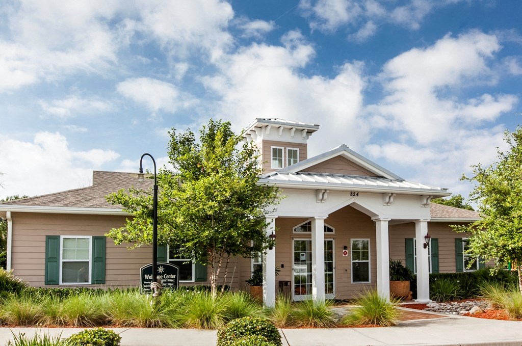 a house with a porch and a tree in front of it