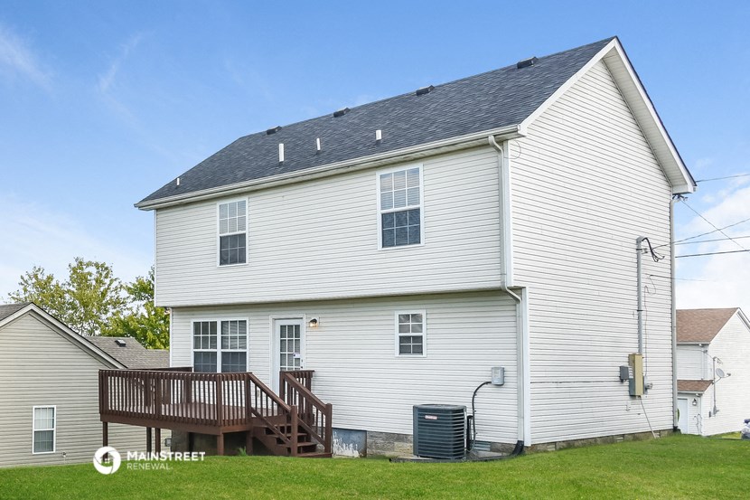 a white house with a porch and a deck