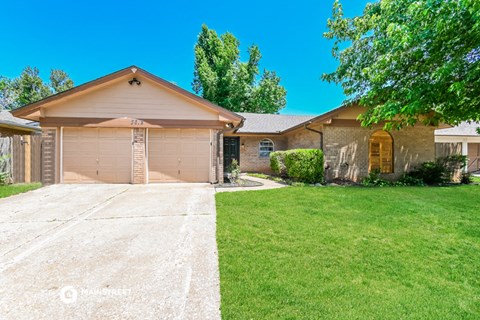 a home with a driveway and a garage door