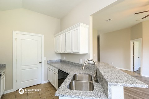 a kitchen with granite counter tops and a sink