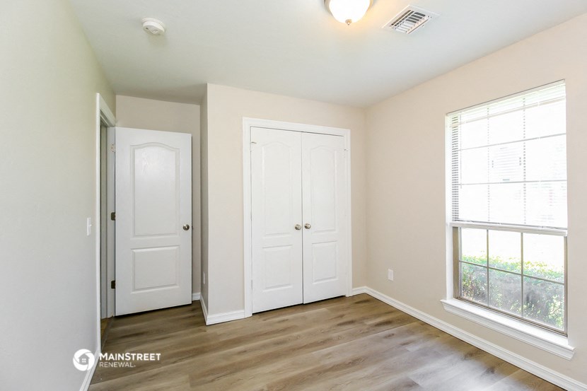 the living room of a new home with white doors and a window