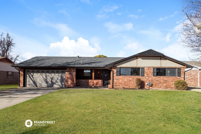 a brick house with a lawn in front of it