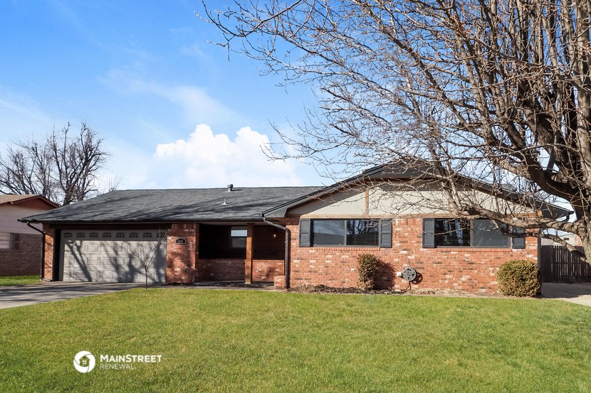 a brick house with a lawn in front of it