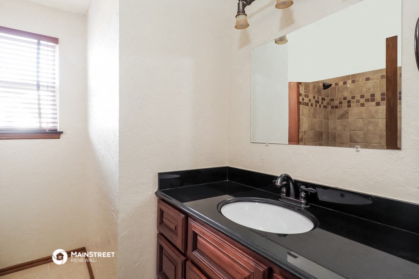 a bathroom with a sink and a mirror