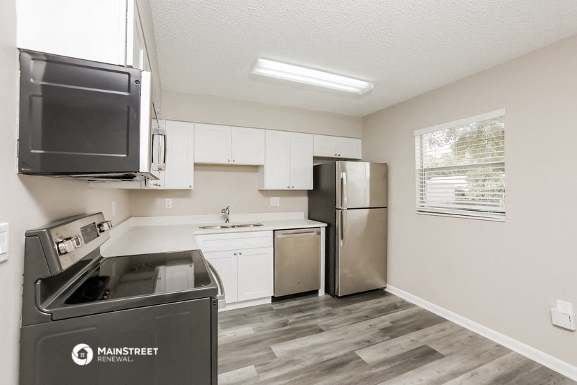 the kitchen of our studio apartment atrium with stainless steel appliances and white cabinets