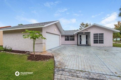 a white house with a driveway and a garage door