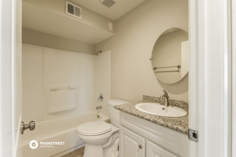 a bathroom with a sink and a toilet and a bath tub